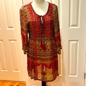 Lightweight, 3/4 sleeve dress with touching on sides and tassels on tie